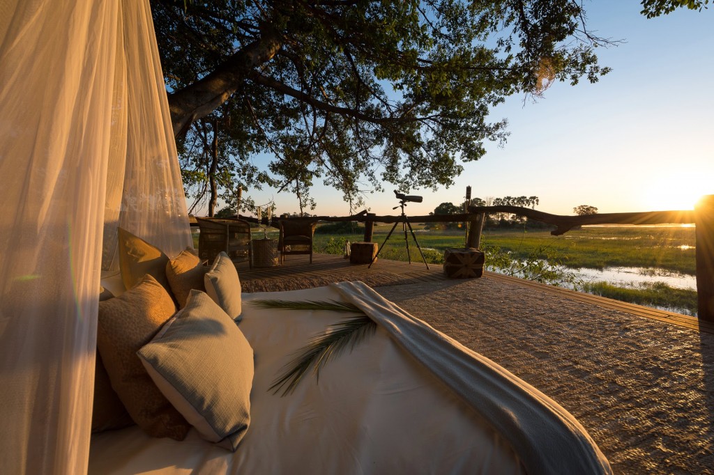 Sunrise in an open bedroom and long range lens camera Okavango Delta scenery at Tubu Tree Camp