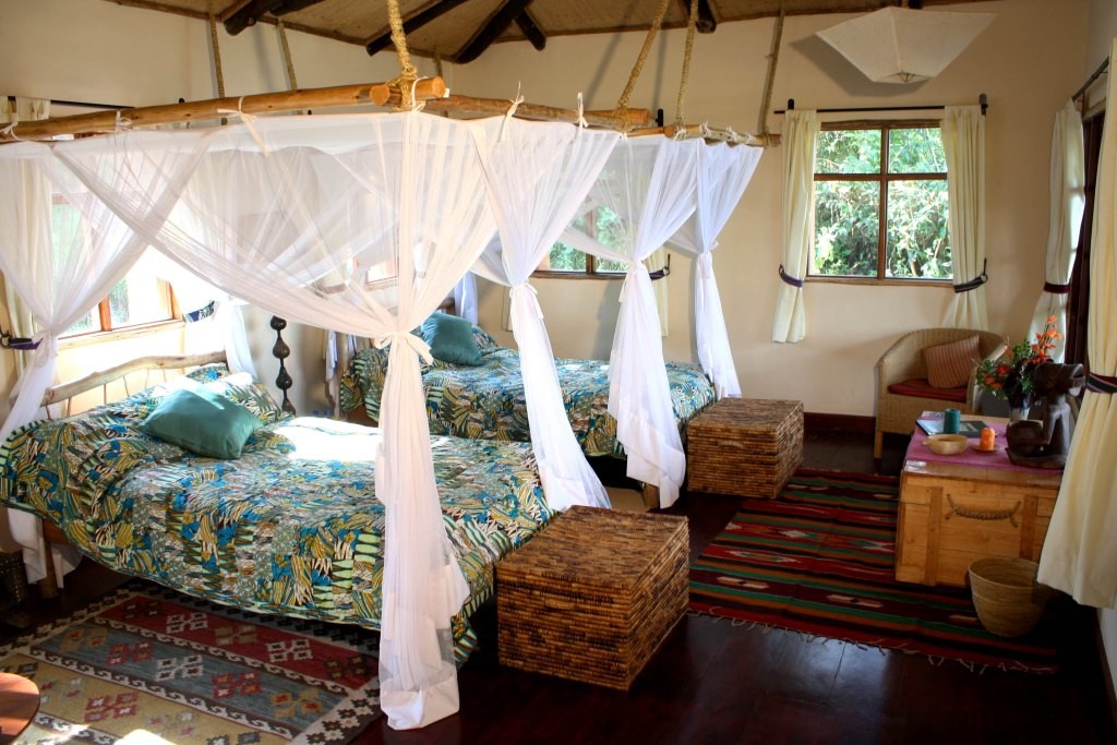Cosy lodgings and four poster luxury Image credit: Virunga Lodge, Rwanda