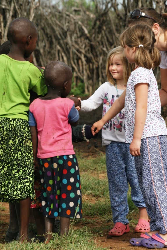 Children shaking hands from different nationalities
