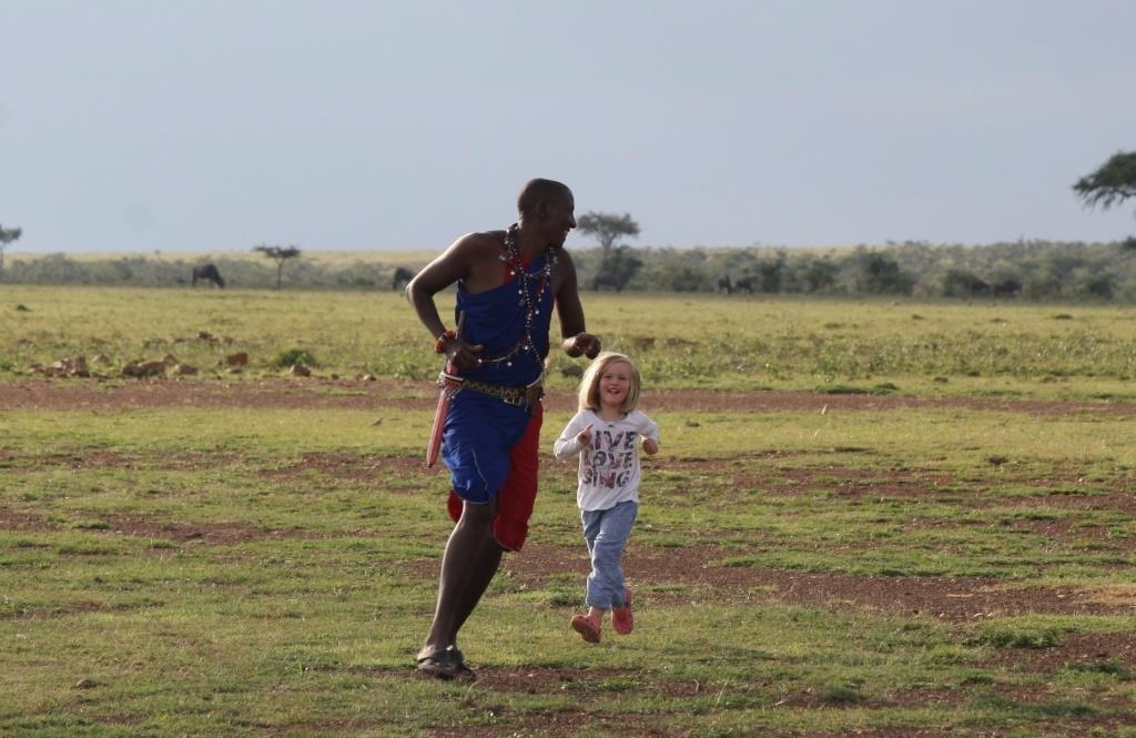 Maasai man David playing with a young girl