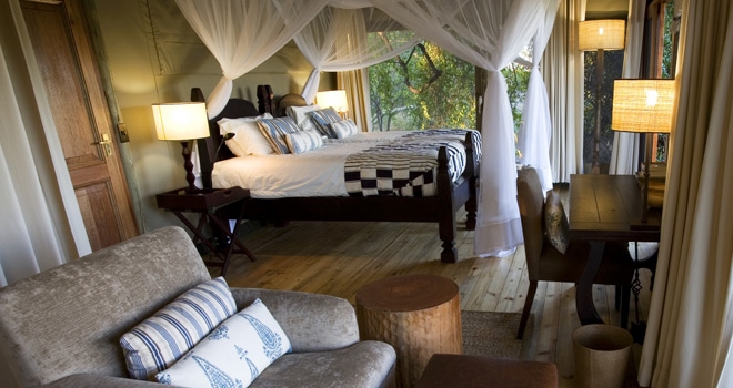 Luxury balc and white four poster Bedroom at Little Vumbura, Okavango Delta, Botswana