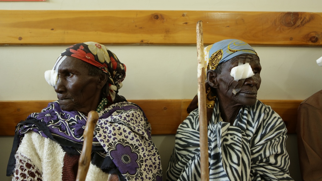 Two elderly ladies recovering from treatment with patches over one eye