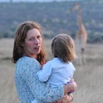 Alice with her daughter, with giraffes, Kenya
