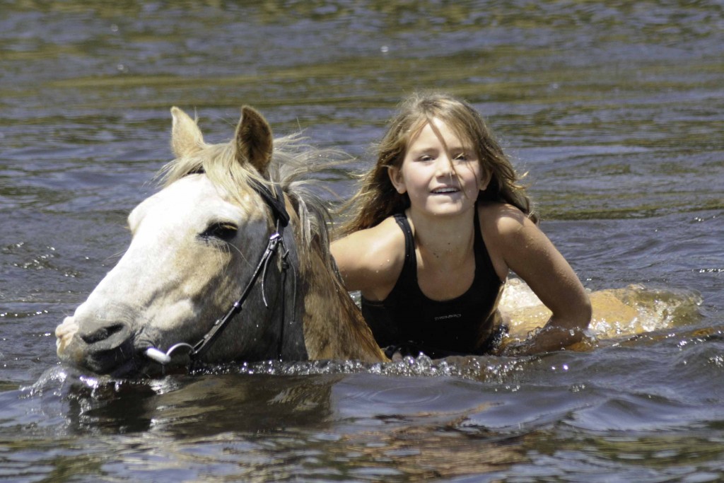 Girl swimming with grey horse, Horizon Horseback, Waterburg, South Africa