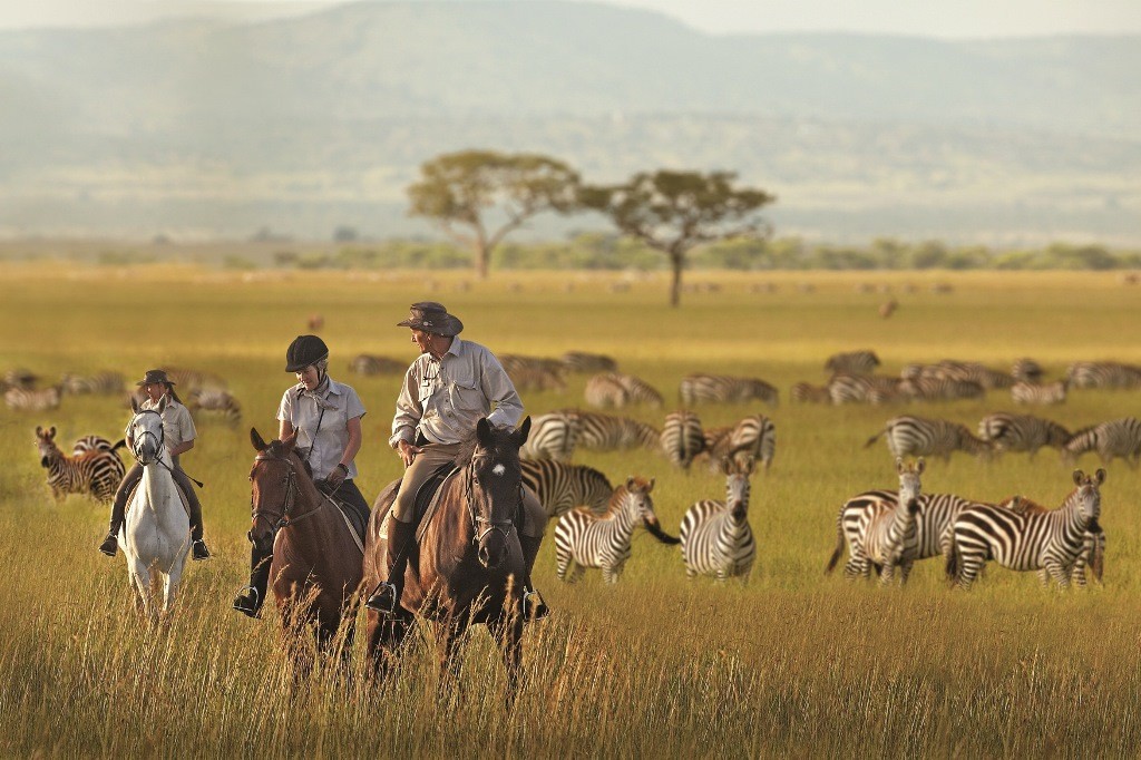 Riders walking with a zebra herd, Singita Grumeti, Tanzania