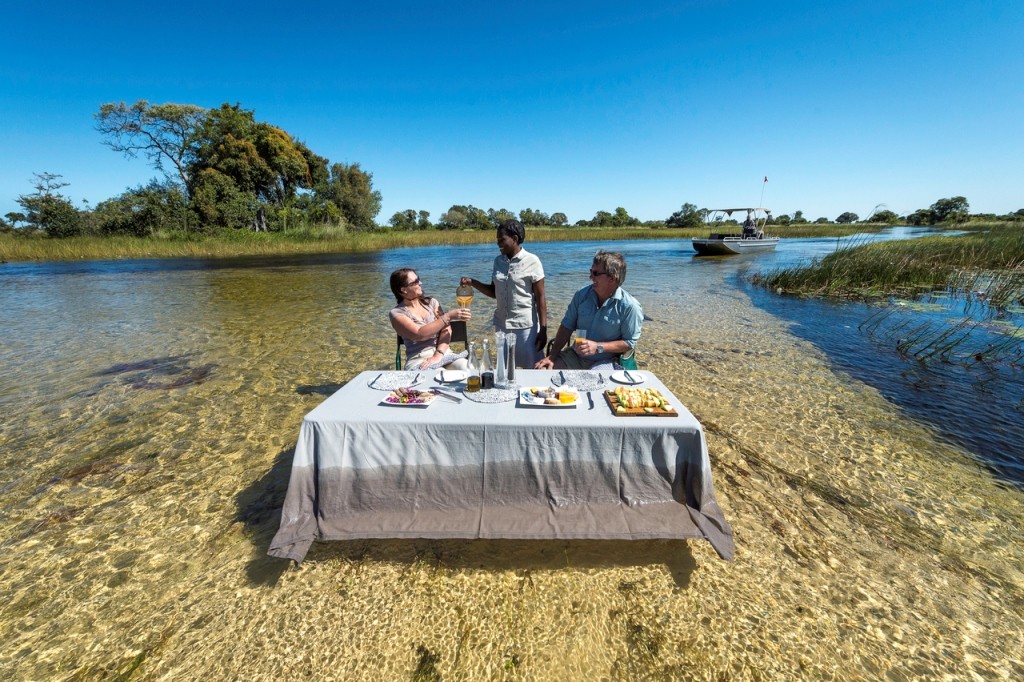 Dining on the river, Pelo Camp, Okavango Delta, Botswana
