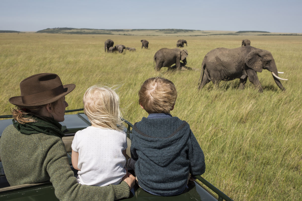 Rekero Camp children viewing elephants from safari drive Masai Mara, Kenya