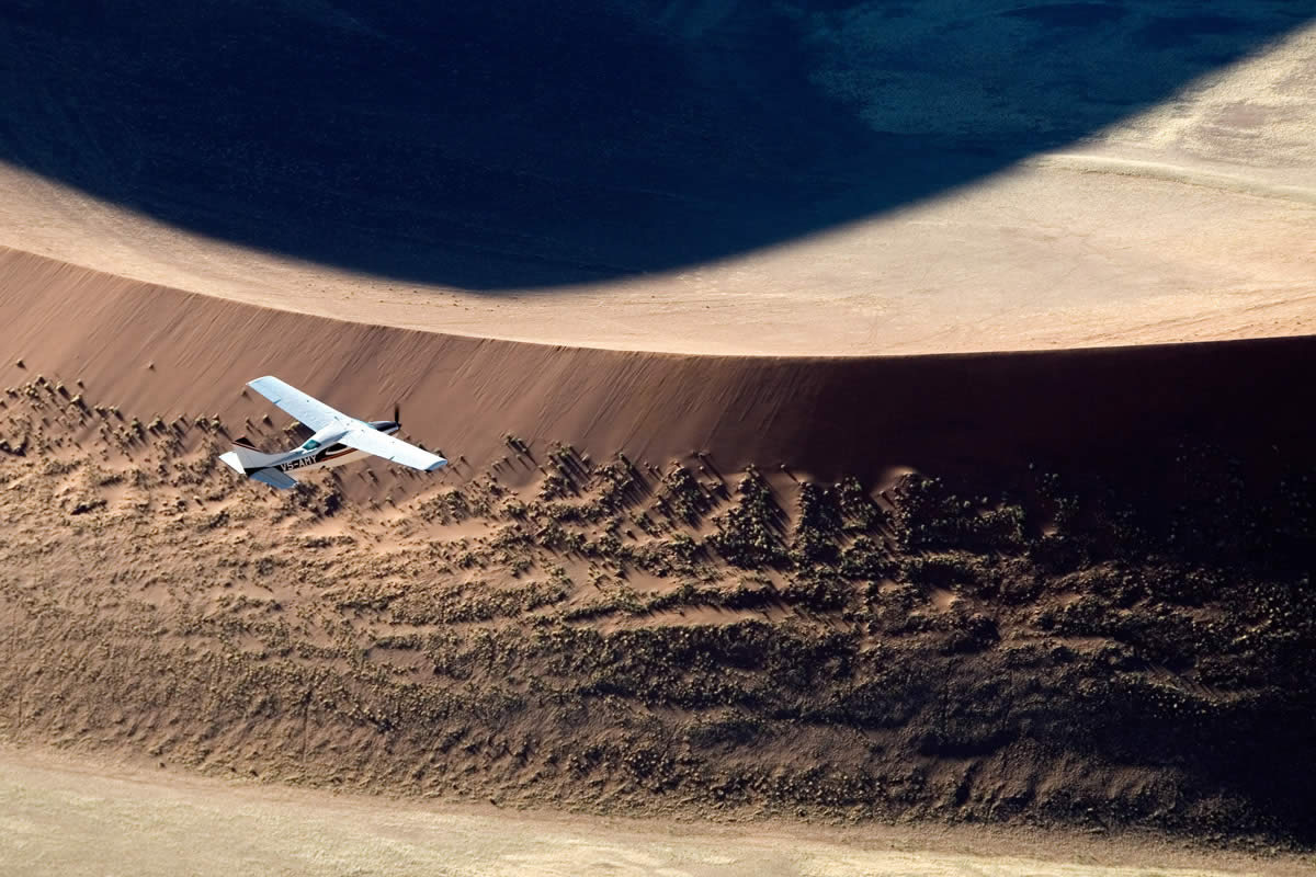 Skeleton Coast Safaris flying over Namibia dunes