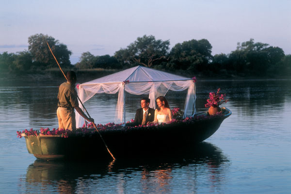 aardvark safaris facts - Robin Pope Safaris wedding couple on a boat Zambia