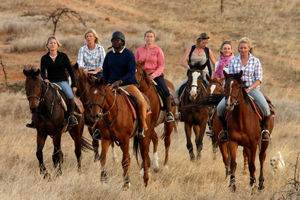 Guide with ladies riding group walking at Borana Riding, Kenya