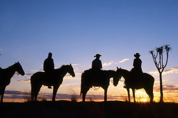 Fish River Canyon group of riders in silhouette Namibia Horse Safaris