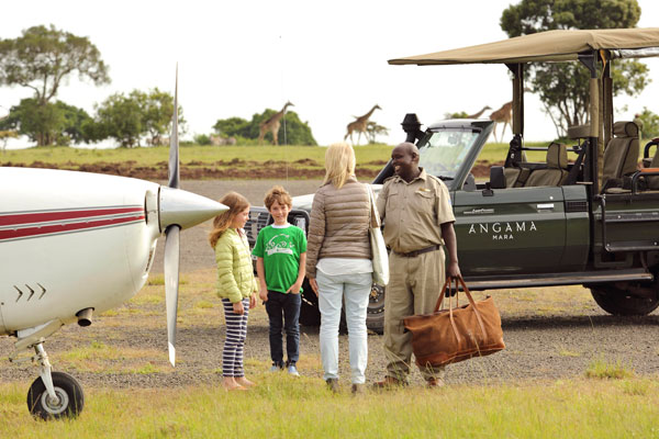 Family arriving on bush plane at Angama Mara Masai Mara Kenya