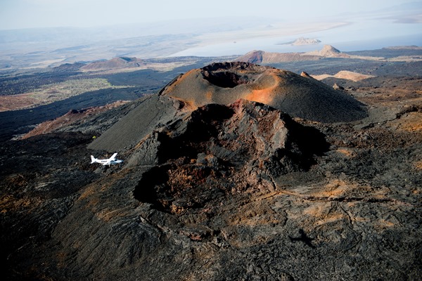 volcanic landscape scattered with dramatic calderas and blackened lava flows
