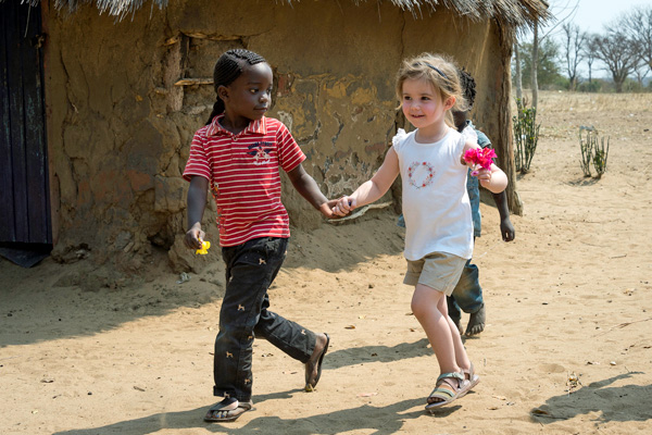 Children playing in a local Zambian village family safari experiences 