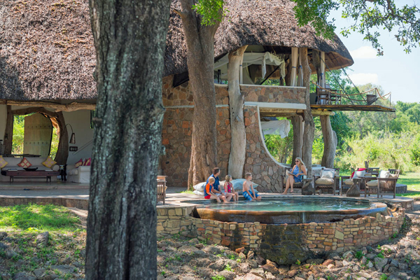 Family time relaxing by the pool, Luangwa House, South Luangwa, Zambia