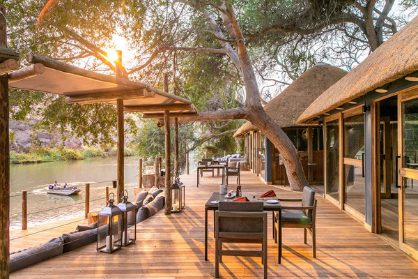 Glorious dining setting overlooking the Kunene River, Serra Cafema, Wilderness Safaris