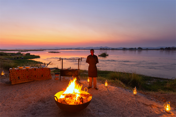 Sundowners and camp fire by the river, Mana Pools, Zimbabwe, Sapi Explorers